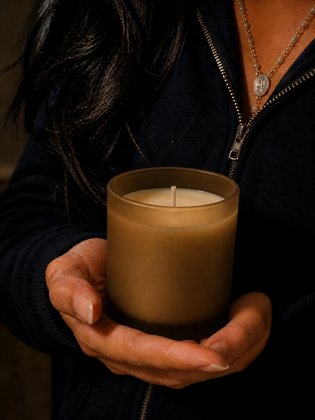 Person holding a frosted glass lavender candle, Provence-inspired artisanal product